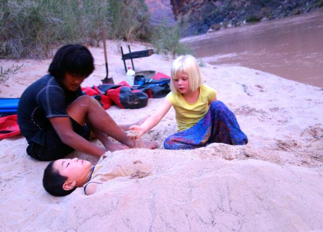 Burying other kids in sand is a great way for kids to pass time on a Grand Canyon Whitewater trip. 