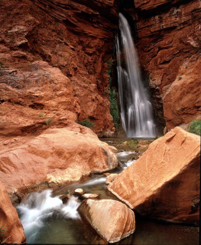 Grand Canyon Whitewater guests will pass Deer Creek Falls, which drops more than 100 feet, on their tour.