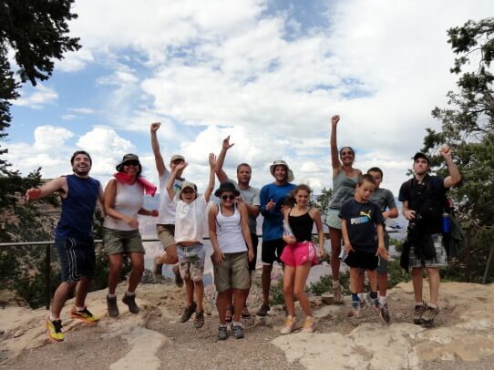 Grand Canyon Whitewater guests celebrate upon reaching the South Rim after a 9-mile hike out of Grand Canyon.