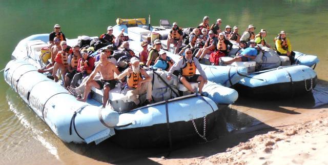 rafters pose for a group photo on the motorized rafts that took them through the Canyon