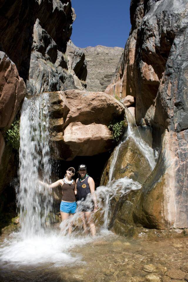 Grand Canyon Whitewater guests cool off in refreshing Clear Creek falls.