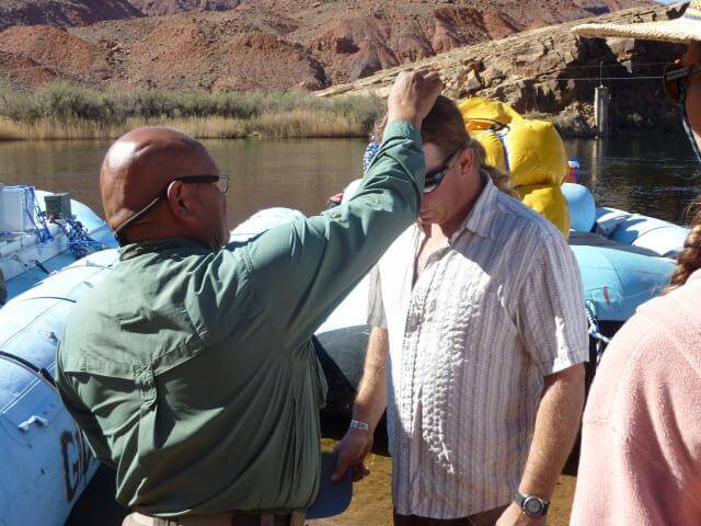 Brock, a Grand Canyon Whitewater guide, receives a Hopi blessing before the river trip.