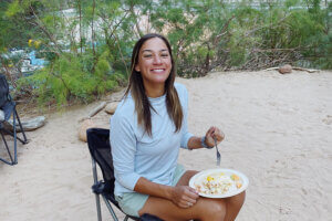 Lilli Higgins eating breakfast in a chair