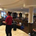 Shuttle driver checking in guests in the lobby.