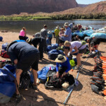 Guests at Lees Ferry packing their things into our dry bags.
