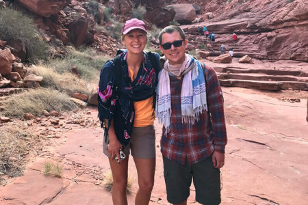 Young couple wearing sarongs around their necks.