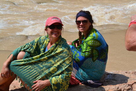 Young women covered up with sarongs in the heat.