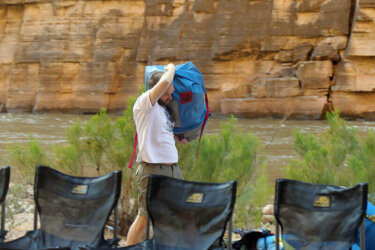 Man carrying bag in camp