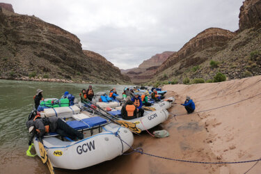 Oar boats in camp with a steep beach