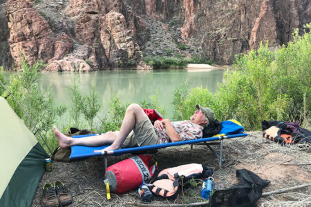 Reading on a river trip cot