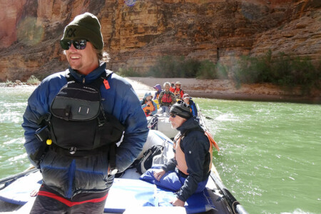 River guide with a puffy jacket on smiling
