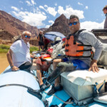 Man with a prosthetic leg smiling on a boat.