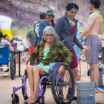 A woman in a wheelchair washes her hands.