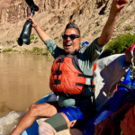 A man took off his prosthetic leg and raised it in the air.